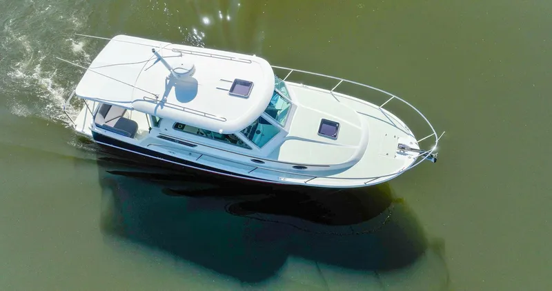 Slide: The Image of 2018 Back Cove 32 boat cruising on calm water, aerial view. - 40