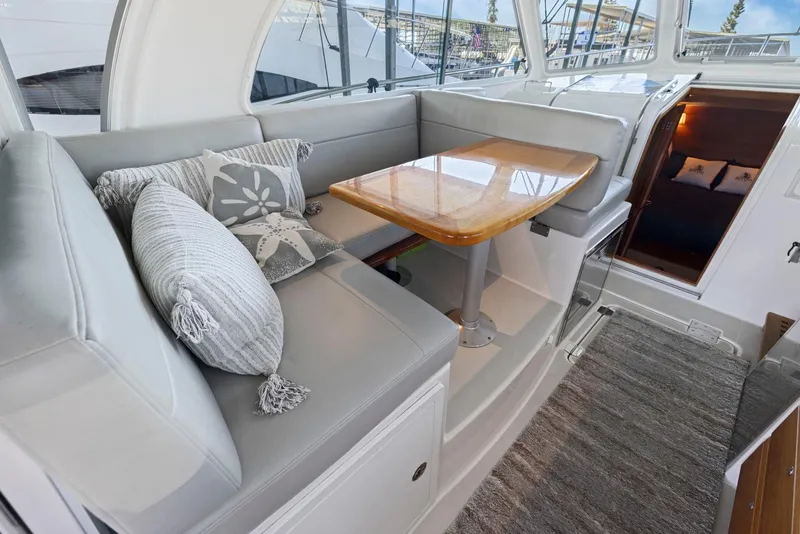 Slide: The Image of Interior of 2018 Back Cove 32 yacht with cozy seating and wooden table. - 44
