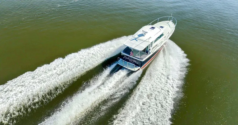 Slide: The Image of 2018 Back Cove 32 boat cruising on open water, creating a dynamic wake. - 6