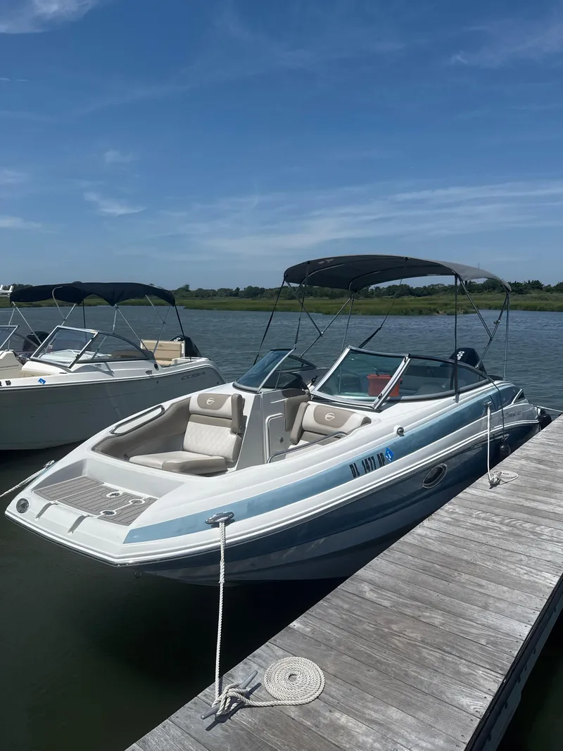 Slide: The Image of 2023 Crownline Eclipse E235 XS boat docked on a sunny day. - 6