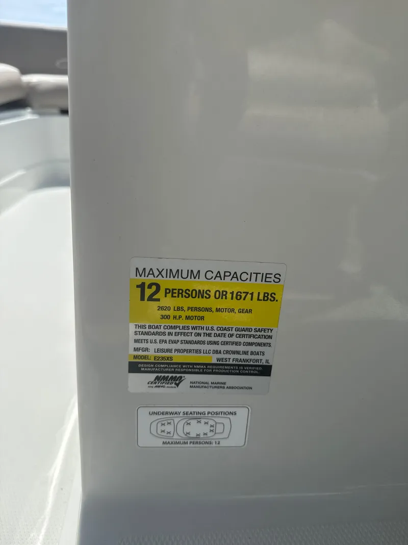 Slide: The Image of Capacity label on 2023 Crownline Eclipse E235 XS, max 12 persons or 1671 lbs. - 9