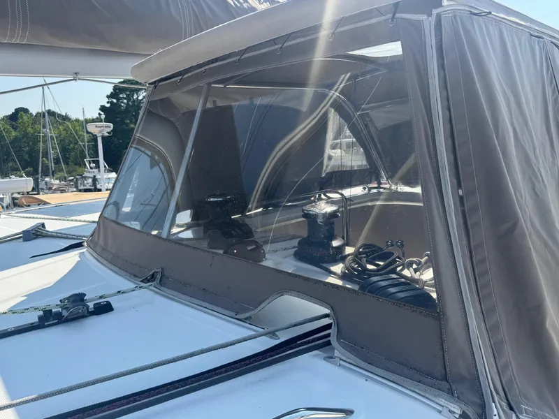 Slide: The Image of 2016 Lagoon 400 S2 yacht with covered cockpit and winch, docked in a marina. - 17