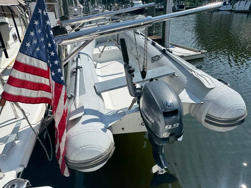 Slide: The Image of Inflatable boat with Yamaha motor on Lagoon 400 S2, 2016, docked with American flag. - 22