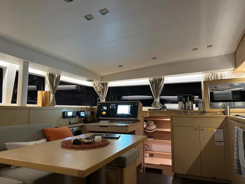 Slide: The Image of Interior of 2016 Lagoon 400 S2 catamaran with modern kitchen and navigation area. - 35