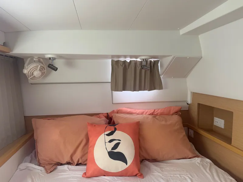 Slide: The Image of Cozy cabin bedroom in 2016 Lagoon 400 S2 catamaran with decorative pillows and fan. - 45