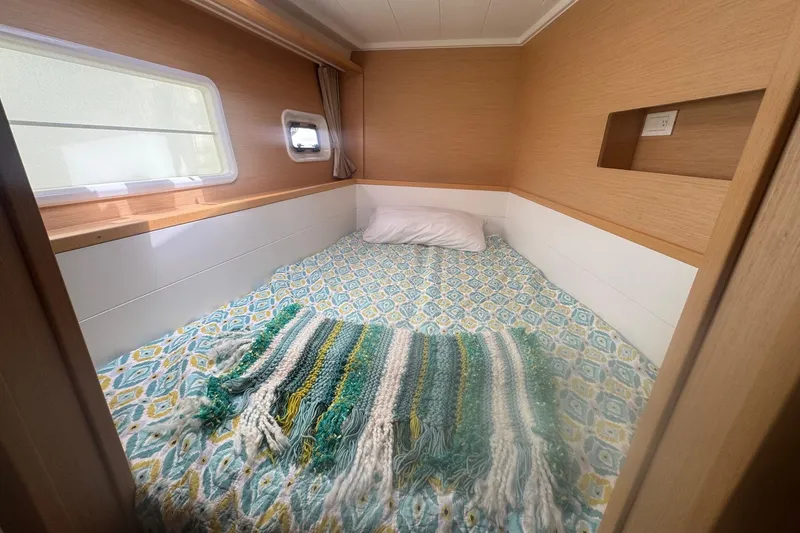 Slide: The Image of Cozy cabin interior of 2016 Lagoon 400 S2 with patterned bedding and window. - 61