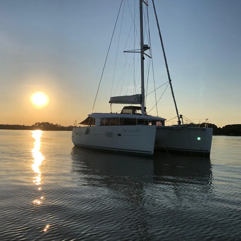 Slide: The Image of 2016 Lagoon 400 S2 catamaran at sunset on calm water. - 79