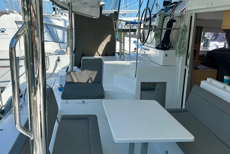 Slide: The Image of 2016 Lagoon 400 S2 yacht interior with seating and table, docked at marina. - 8