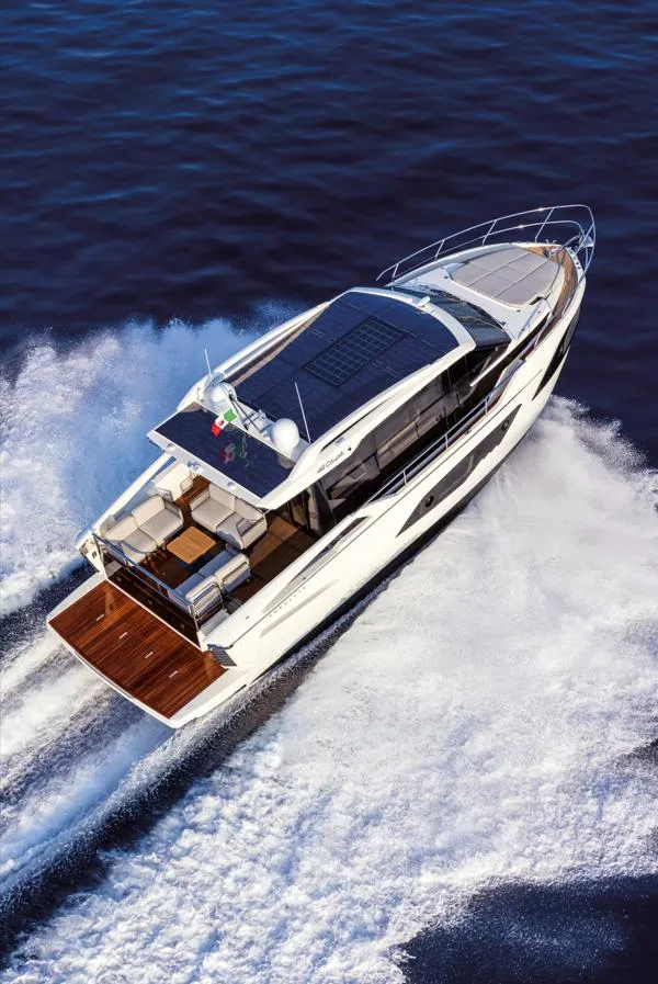Slide: The Image of 2024 Absolute 48 Coupe luxury yacht cruising on open water. - 2