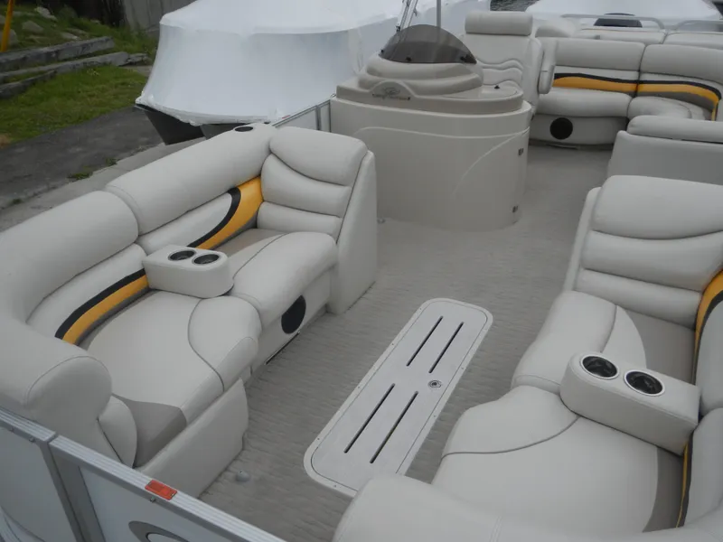 Slide: The Image of Luxurious 2010 Crest III pontoon boat interior with plush seating and cup holders. - 12