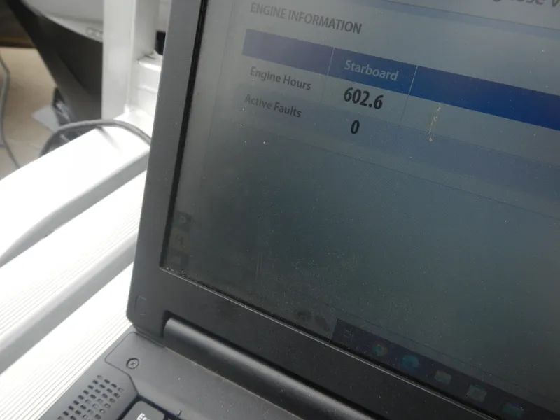 Slide: The Image of Laptop displaying engine information: 602.6 hours, 0 active faults, Crest III 2010. - 14