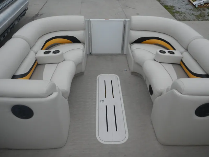 Slide: The Image of 2010 Crest Crest III pontoon boat interior with beige seating and cup holders. - 17