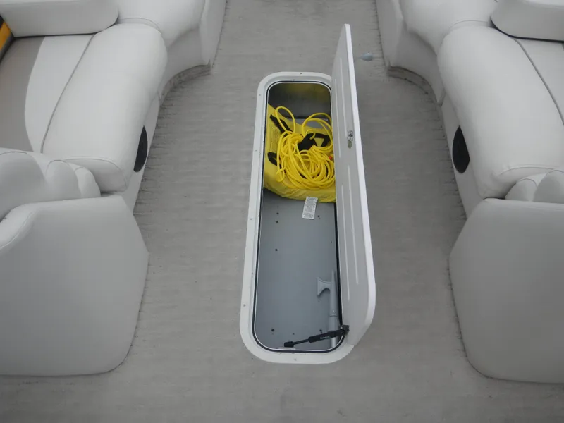Slide: The Image of Open storage compartment on 2010 Crest III boat with yellow rope inside. - 18