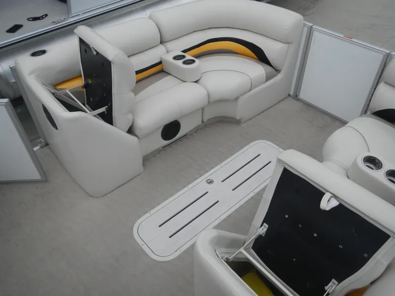 Slide: The Image of Luxurious seating on a 2010 Crest III pontoon boat with cup holders and storage compartments. - 19
