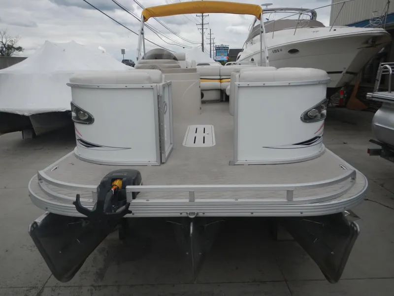 Slide: The Image of 2010 Crest Crest III pontoon boat with yellow canopy, docked at marina. - 3