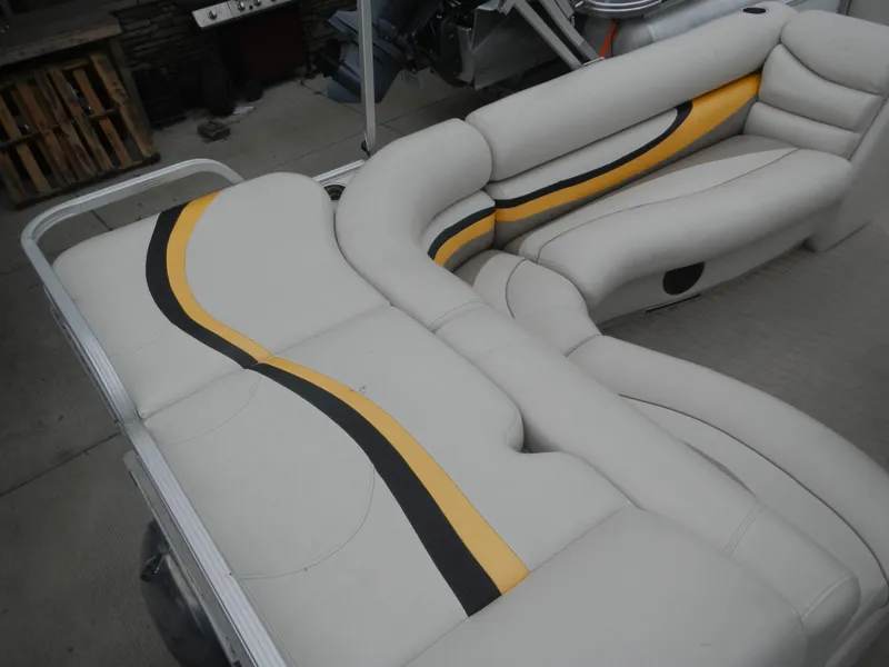 Slide: The Image of Crest III 2010 boat seating with white upholstery and yellow-black accents. - 5