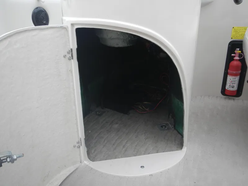 Slide: The Image of Open storage compartment on a 2010 Crest III boat with visible fire extinguisher. - 6
