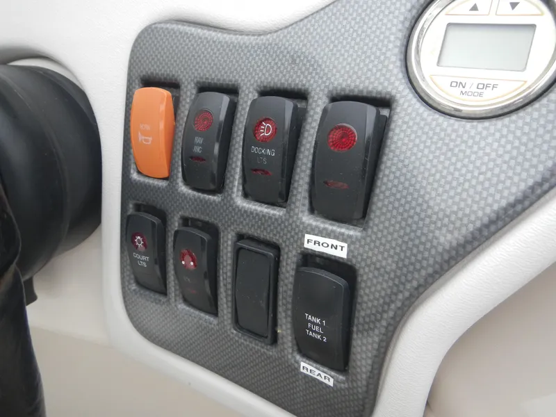 Slide: The Image of Control panel of a 2010 Crest III boat with various switches and a digital display. - 7