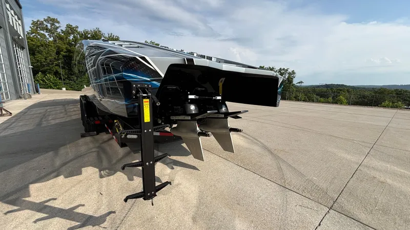 Slide: The Image of 2025 Outerlimits 50 SL Crypto II boat on trailer, showcasing sleek design and powerful propellers. - 10