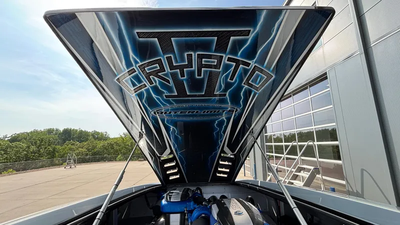 Slide: The Image of 2025 Outerlimits 50 SL Crypto II boat with open engine hatch displaying logo. - 19