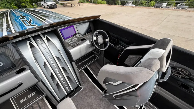 Slide: The Image of Interior of 2025 Outerlimits 50 SL Crypto II boat with modern dashboard and seating. - 31