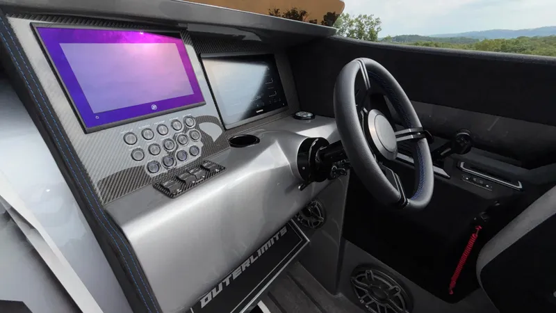 Slide: The Image of Cockpit of 2025 Outerlimits 50 SL Crypto II with modern steering and digital displays. - 33