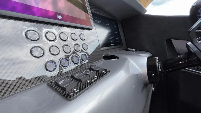 Slide: The Image of Dashboard of 2025 Outerlimits 50 SL Crypto II with carbon fiber finish and control buttons. - 39