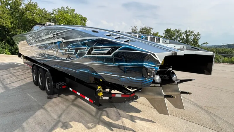 Slide: The Image of 2025 Outerlimits 50 SL Crypto II powerboat on trailer, featuring sleek design and vibrant graphics. - 5