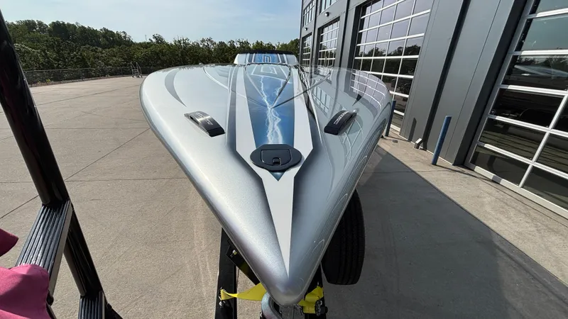 Slide: The Image of 2025 Outerlimits 50 SL Crypto II speedboat, sleek design, parked near modern building. - 6