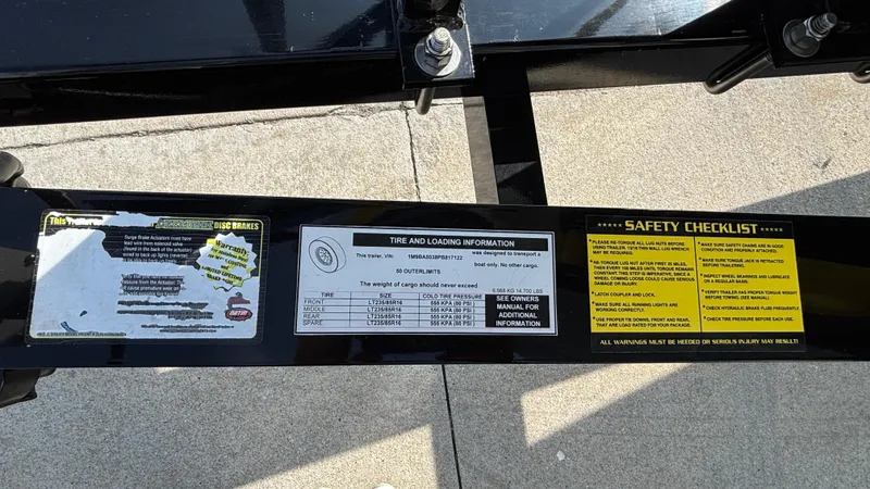 Slide: The Image of Trailer safety and tire information labels on Outerlimits 50 SL Crypto II, 2025 model. - 8