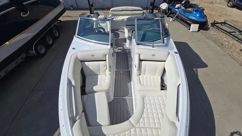 Slide: The Image of 2017 Cobalt R5 WSS Surf boat with white interior, docked beside other watercraft. - 10