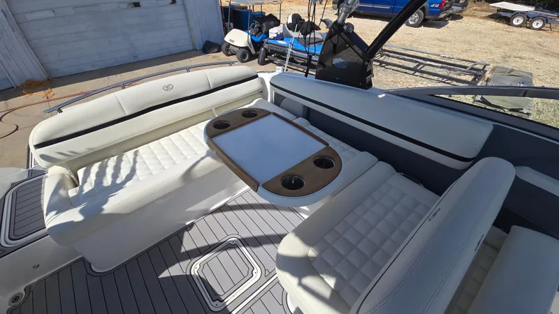 Slide: The Image of 2017 Cobalt R5 WSS Surf boat interior with white seating and table. - 15