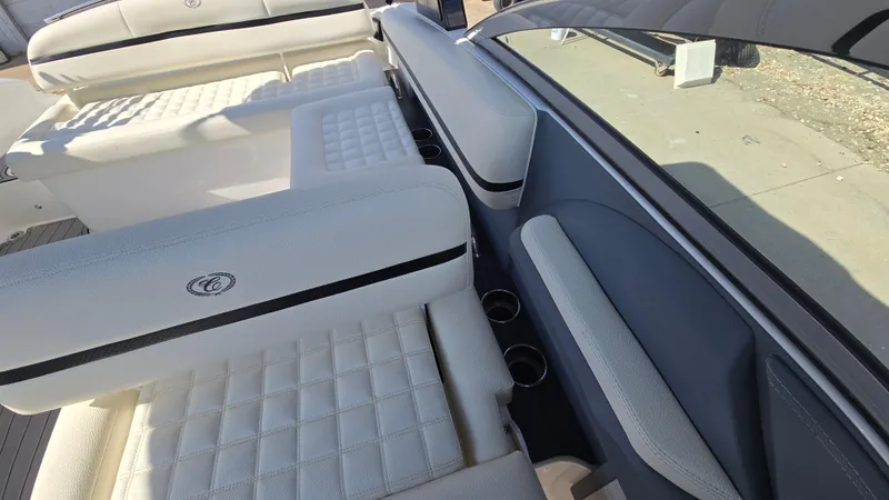 Slide: The Image of 2017 Cobalt R5 WSS Surf boat interior with white quilted seating and cup holders. - 18