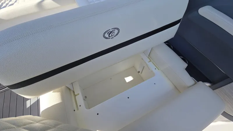 Slide: The Image of 2017 Cobalt R5 WSS Surf boat seat with storage compartment, featuring white upholstery. - 19