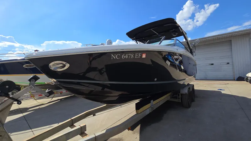 Slide: The Image of 2017 Cobalt R5 WSS Surf boat on trailer under clear blue sky. - 2