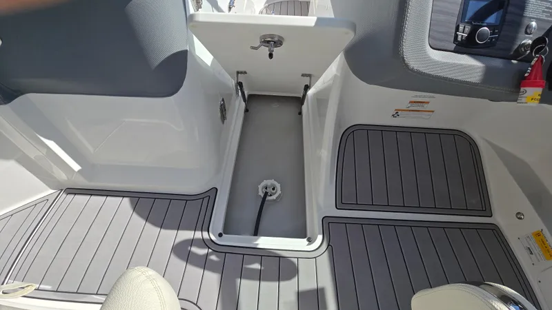 Slide: The Image of 2017 Cobalt R5 WSS Surf boat interior with open storage compartment and gray flooring. - 20