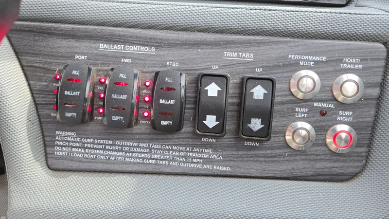 Slide: The Image of Control panel of a 2017 Cobalt R5 WSS Surf boat with ballast and trim tab controls. - 27