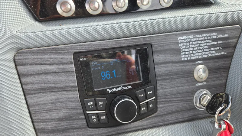 Slide: The Image of Dashboard of a 2017 Cobalt R5 WSS Surf boat with radio and ignition keys. - 28