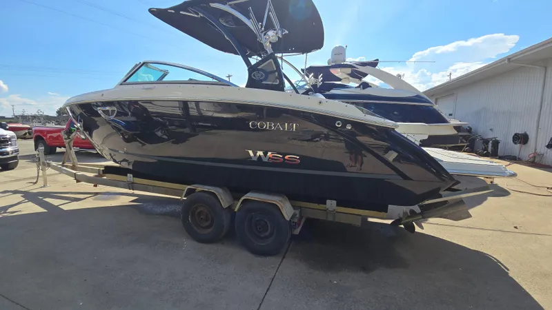 Slide: The Image of 2017 Cobalt R5 WSS Surf boat on trailer, parked outdoors under clear sky. - 3