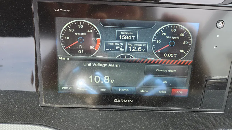 Slide: The Image of Garmin display showing unit voltage alarm on 2017 Cobalt R5 WSS Surf boat. - 31