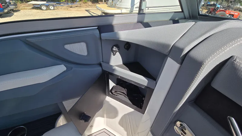 Slide: The Image of Interior view of a 2017 Cobalt R5 WSS Surf boat, featuring sleek gray upholstery. - 33