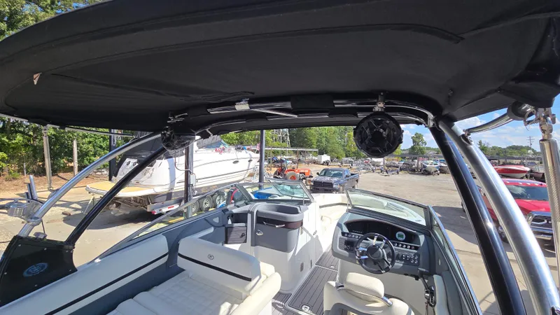 Slide: The Image of 2017 Cobalt R5 WSS Surf boat interior with steering wheel and seating, docked outdoors. - 34