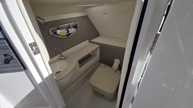 Slide: The Image of 2017 Cobalt R5 WSS Surf boat interior bathroom with sink and toilet. - 35