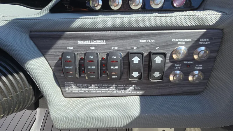 Slide: The Image of Control panel of a 2017 Cobalt R5 WSS Surf boat with ballast and trim tab controls. - 41