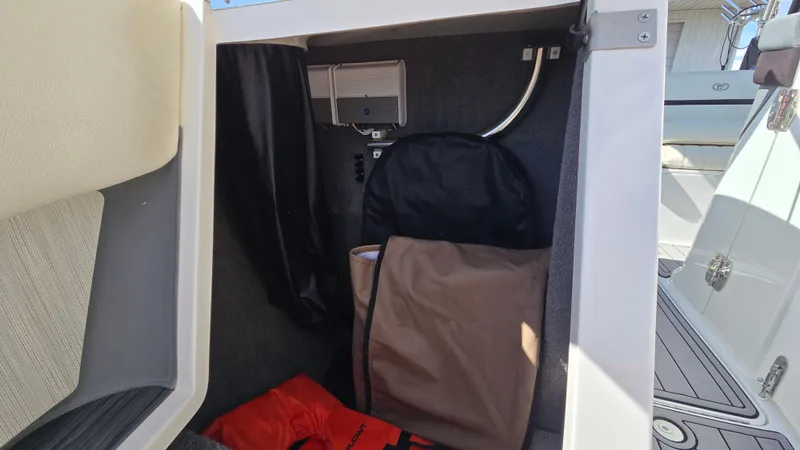 Slide: The Image of Storage compartment in a 2017 Cobalt R5 WSS Surf boat with life jackets and equipment. - 46