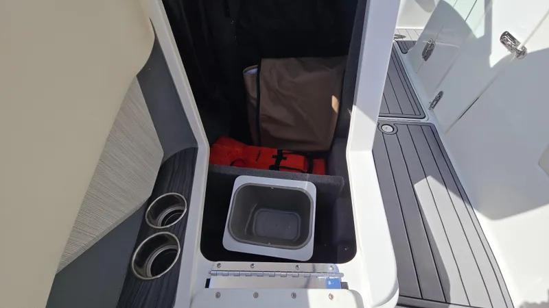 Slide: The Image of Interior of 2017 Cobalt R5 WSS Surf boat with storage compartment and cup holders. - 47