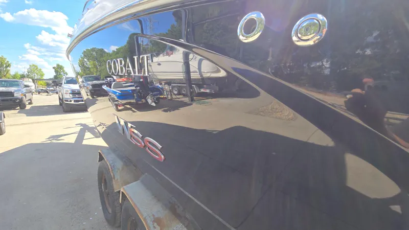Slide: The Image of 2017 Cobalt R5 WSS Surf boat parked outdoors on a sunny day. - 8