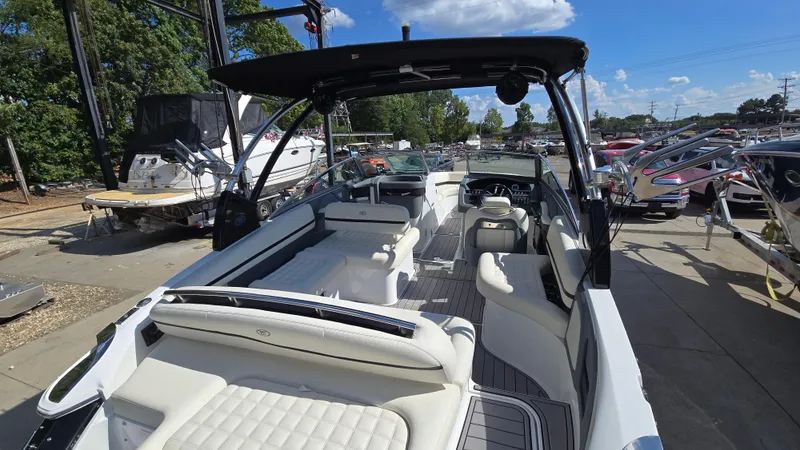 Slide: The Image of 2017 Cobalt R5 WSS Surf boat with spacious seating at a marina. - 9