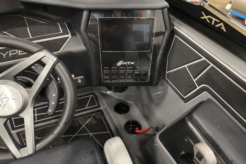 Slide: The Image of 2021 ATX Surf Boats 20 Type-S dashboard with steering wheel and control panel. - 10