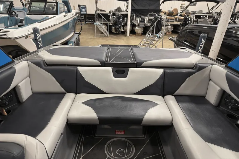 Slide: The Image of 2021 ATX Surf Boats 20 Type-S interior with black and white seating in showroom. - 14